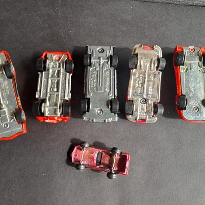 5 Hot Wheel cars and one little metal red car