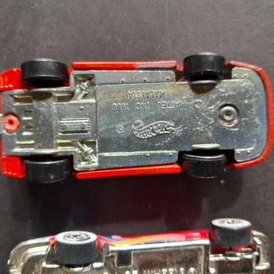 5 Hot Wheel cars and one little metal red car