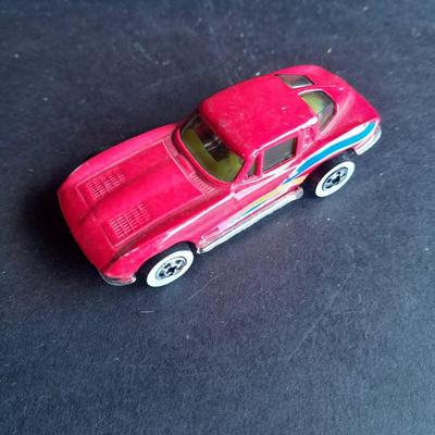 5 Hot Wheel cars and one little metal red car