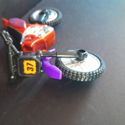 Motorcycle toy, radio flyer wagon, and black Riley MPH