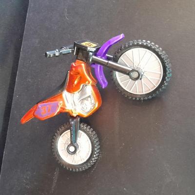Motorcycle toy, radio flyer wagon, and black Riley MPH
