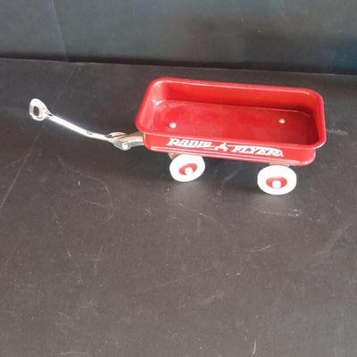 Motorcycle toy, radio flyer wagon, and black Riley MPH