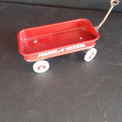 Motorcycle toy, radio flyer wagon, and black Riley MPH