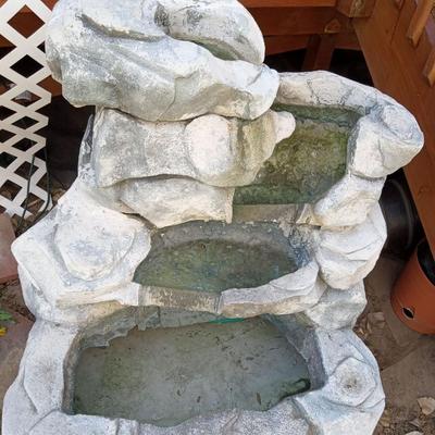 A FAIRLY LARGE OUTDOOR WATER FEATURE/FOUNTAIN