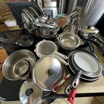 A pile of pots - pans and lids
