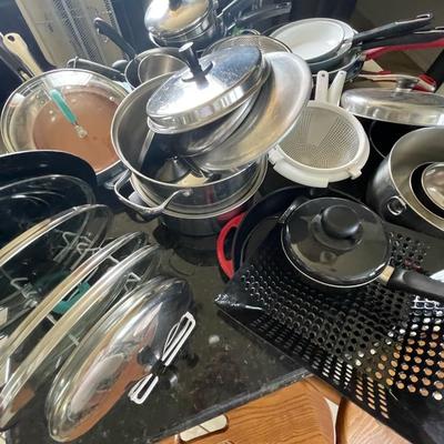 A pile of pots - pans and lids