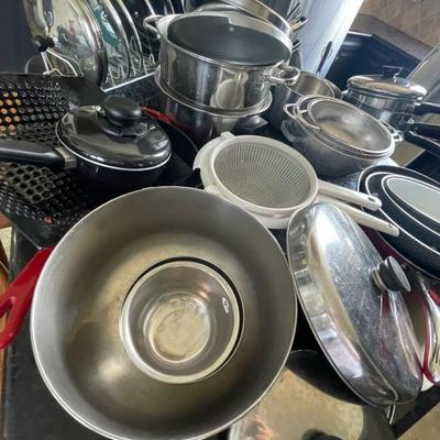 A pile of pots - pans and lids