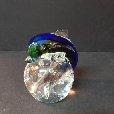 Beautiful blue and green glass Dolphin on clear base with vase of faux flowers