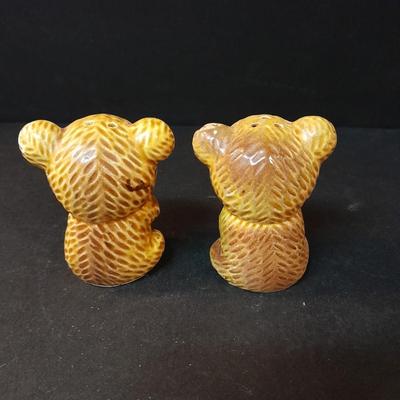 Four-piece lidded glass canister set on wooden Lazy Susan with vintage salt & pepper bear shakers