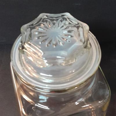 Four-piece lidded glass canister set on wooden Lazy Susan with vintage salt & pepper bear shakers