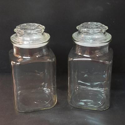 Four-piece lidded glass canister set on wooden Lazy Susan with vintage salt & pepper bear shakers
