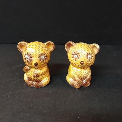 Four-piece lidded glass canister set on wooden Lazy Susan with vintage salt & pepper bear shakers