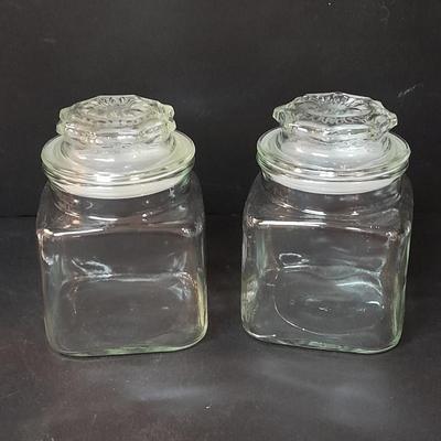 Four-piece lidded glass canister set on wooden Lazy Susan with vintage salt & pepper bear shakers