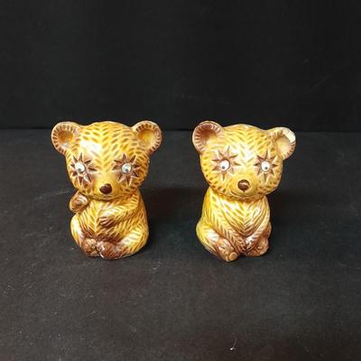 Four-piece lidded glass canister set on wooden Lazy Susan with vintage salt & pepper bear shakers