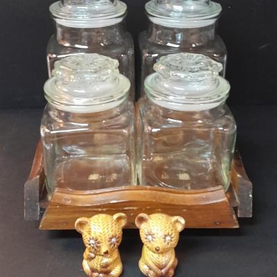 Four-piece lidded glass canister set on wooden Lazy Susan with vintage salt & pepper bear shakers