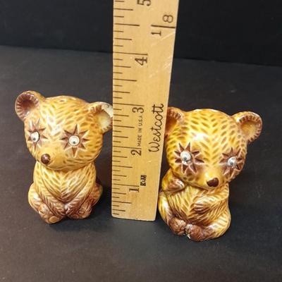 Four-piece lidded glass canister set on wooden Lazy Susan with vintage salt & pepper bear shakers