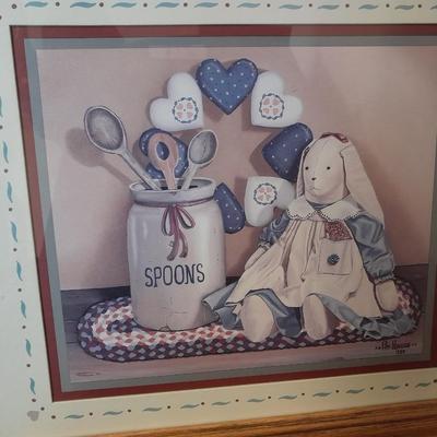 Wooden doll bench with two rabbits and a framed picture