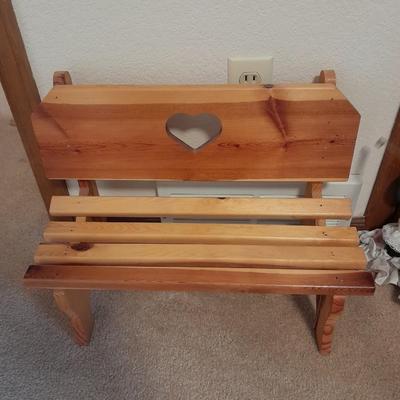 Wooden doll bench with two rabbits and a framed picture