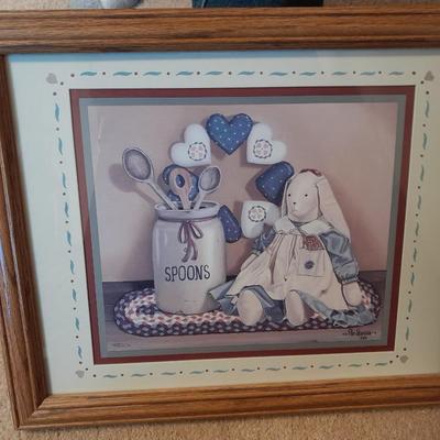 Wooden doll bench with two rabbits and a framed picture