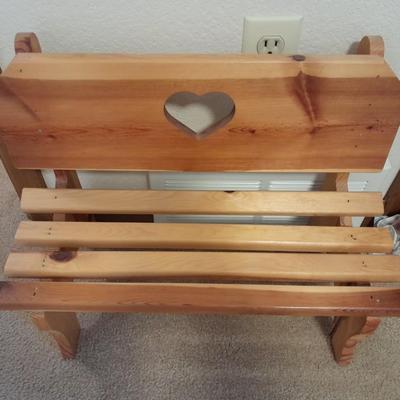 Wooden doll bench with two rabbits and a framed picture