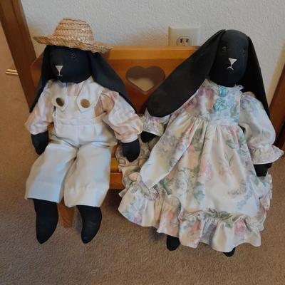Wooden doll bench with two rabbits and a framed picture