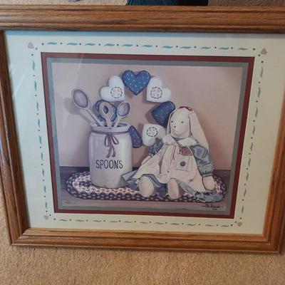 Wooden doll bench with two rabbits and a framed picture