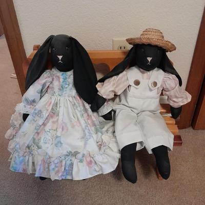 Wooden doll bench with two rabbits and a framed picture