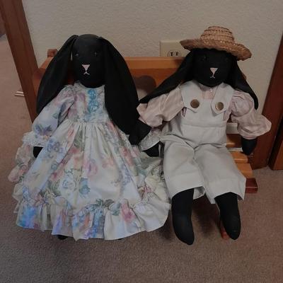 Wooden doll bench with two rabbits and a framed picture