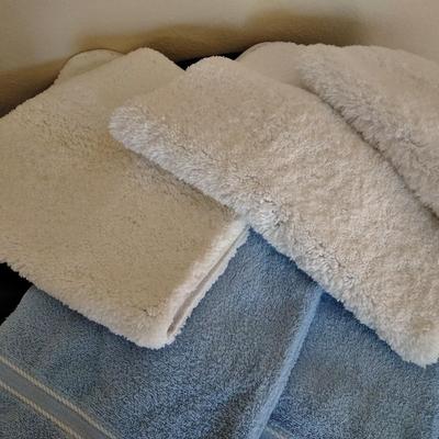 3 piece White Bath rug set with a few blue towels