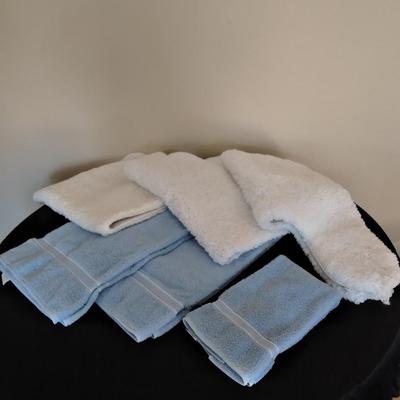 3 piece White Bath rug set with a few blue towels
