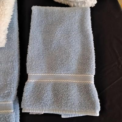 3 piece White Bath rug set with a few blue towels