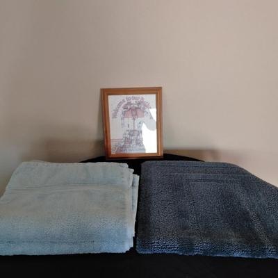 Bath rug, towels and framed bath themed wall art