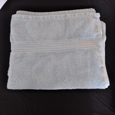 Bath rug, towels and framed bath themed wall art