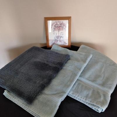 Bath rug, towels and framed bath themed wall art