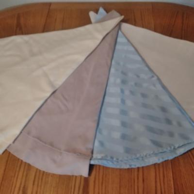 Four round table linens of different colors