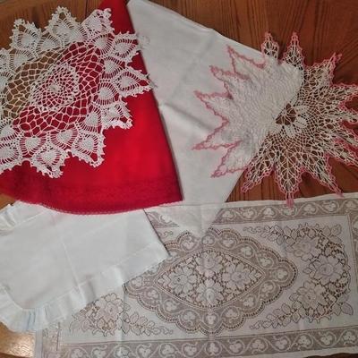 Doilies, round red with lace tablecloth and lace table runner