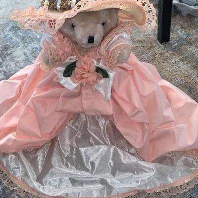 stuffed bear in pretty dress with hat on stand