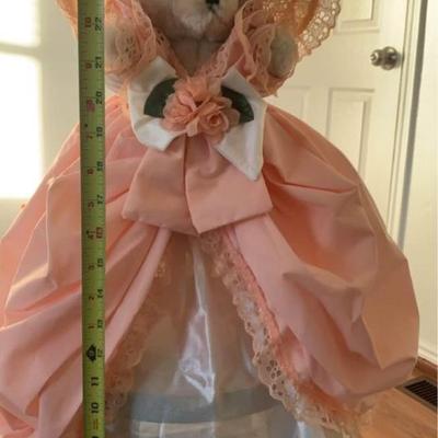 stuffed bear in pretty dress with hat on stand