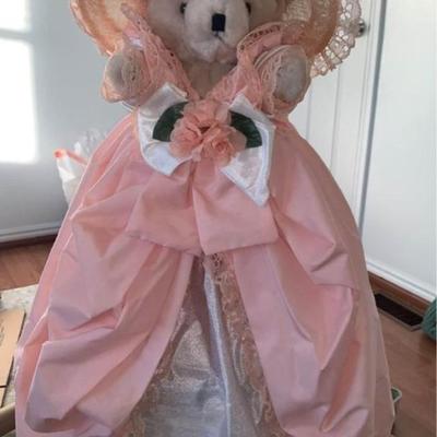 stuffed bear in pretty dress with hat on stand