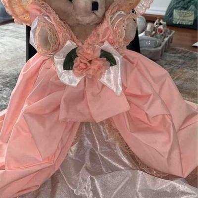 stuffed bear in pretty dress with hat on stand