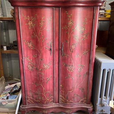 Red wood armoire. 65â€ high, 42â€ wide, 20â€ deep. See description.