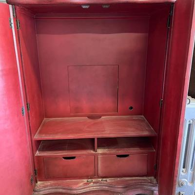Red wood armoire. 65â€ high, 42â€ wide, 20â€ deep. See description.