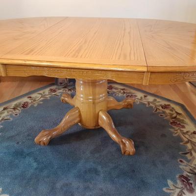 Beautiful Oak round claw footed pedestal Table with 4 chairs and a leaf