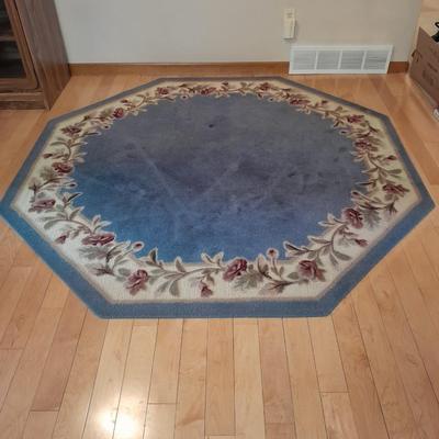 Octagon shaped blue and floral area rug