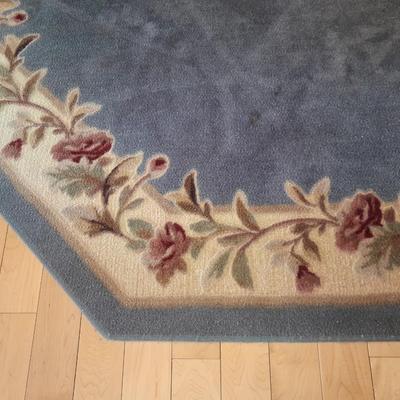 Octagon shaped blue and floral area rug