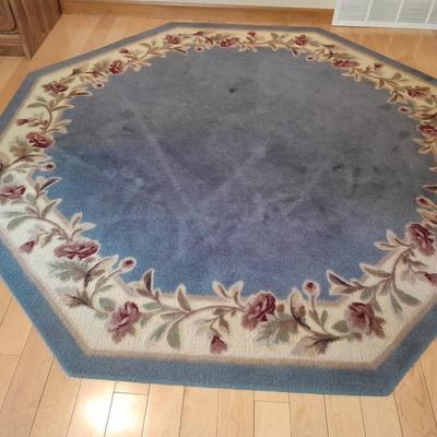 Octagon shaped blue and floral area rug