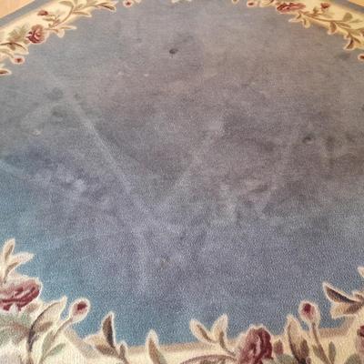 Octagon shaped blue and floral area rug