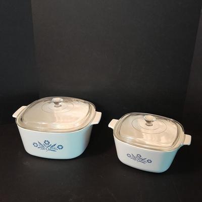 Two Corning ware casserole dishes with lids