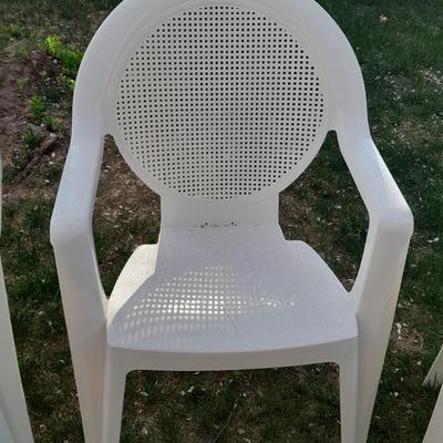Three white plastic Patio chairs