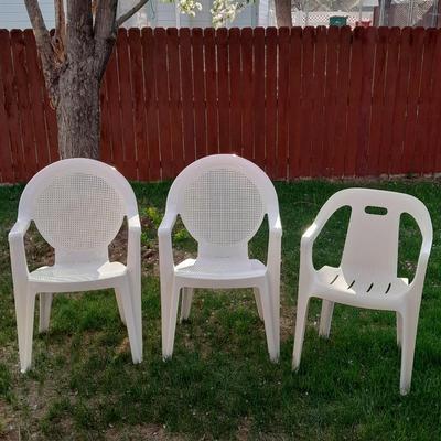 Three white plastic Patio chairs